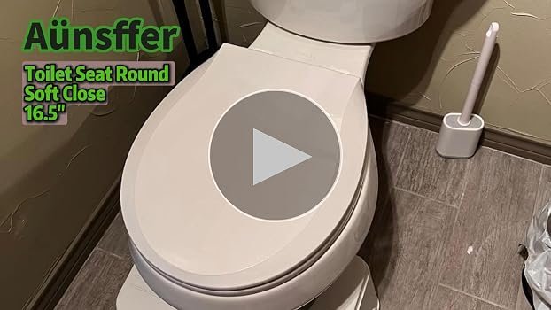 A modern toddler toilet seat is installed on a white toilet in a bright bathroom.