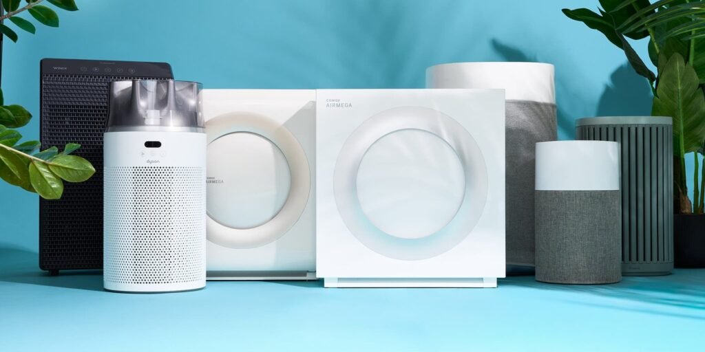 A modern white air purifier placed in a bright and clean living room.