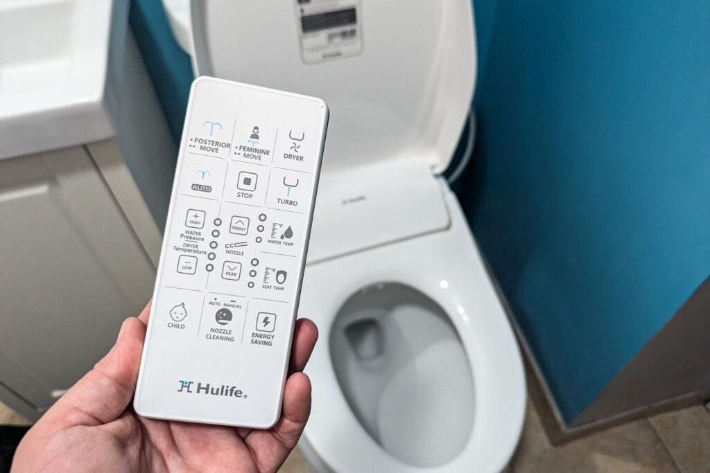 A modern non-electric bidet toilet seat installed in a bright, clean contemporary bathroom.