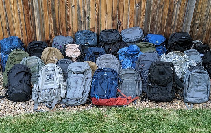 A well-organized bug out bag for families sits ready on a porch.