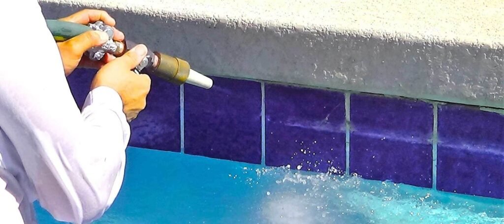 A clean pool tile waterline sparkling in the sun after being professionally cleaned.
