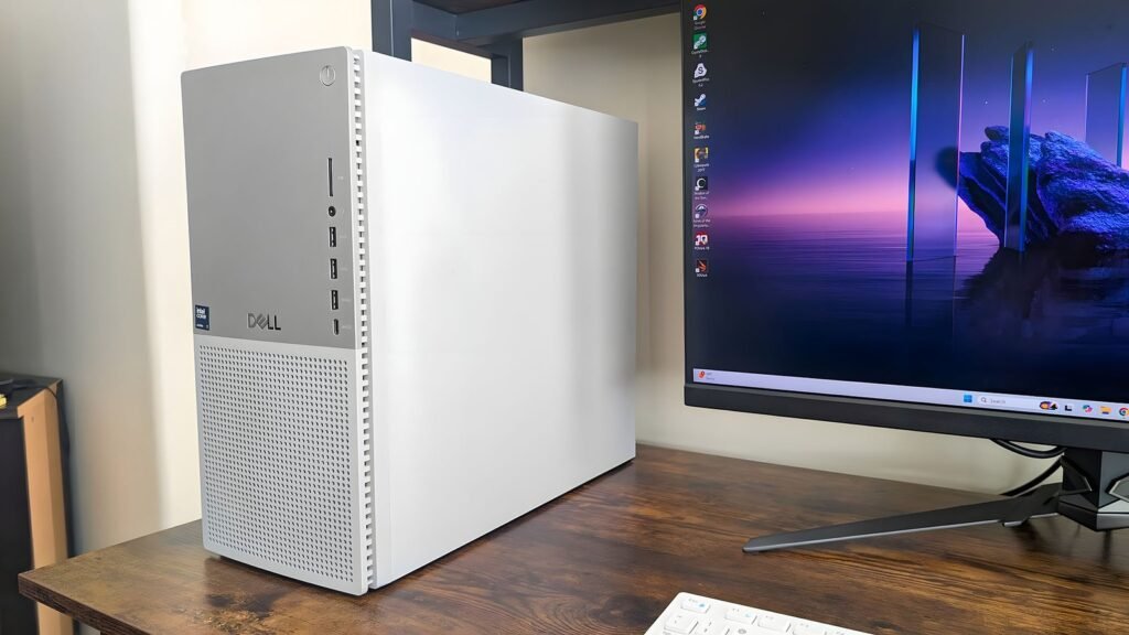 A modern Dell desktop computer setup on a clean wooden home office desk.