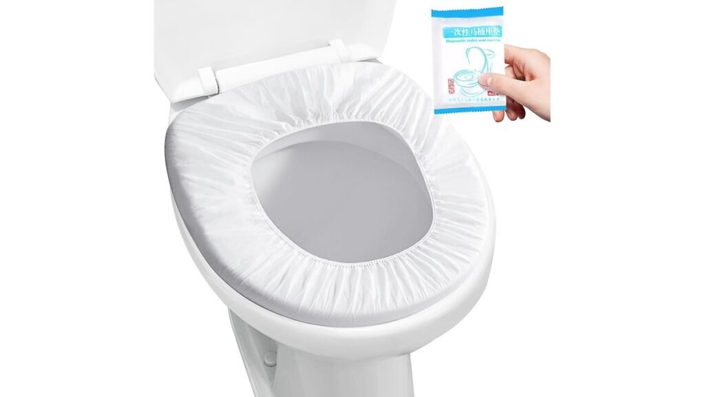 A stack of clean disposable toilet seat covers in a modern public restroom.