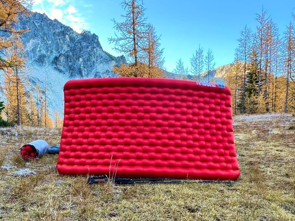 A double sleeping pad set up for backpacking in a beautiful mountain landscape.