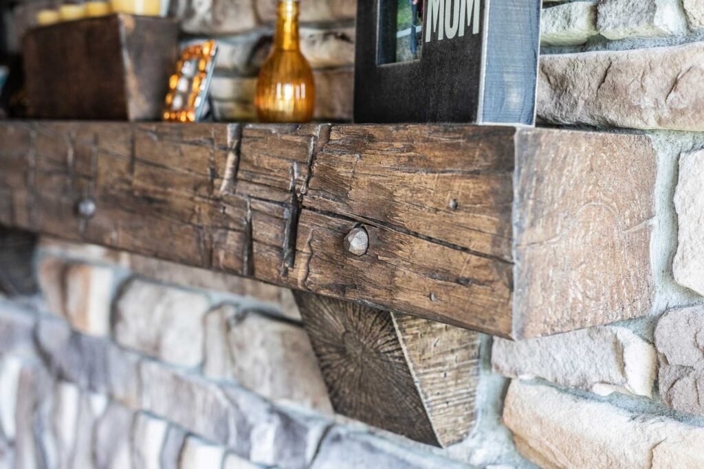A rustic barn beam mantelpiece serves as a beautiful focal point above a fireplace.