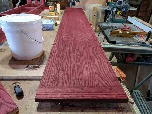 A close-up view of a craftsman applying a high-quality finish to rosewood.