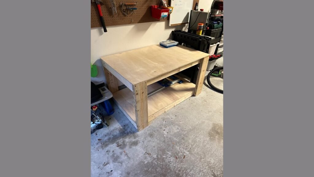 A woodworker applies a protective finish to a sturdy oak workbench top.