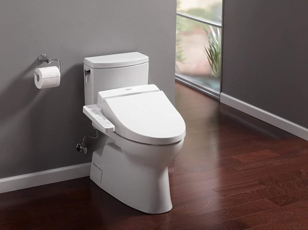 A modern white heated toilet seat installed in a bright, clean contemporary bathroom.