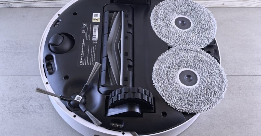 A manual pool vacuum head sits poolside, representing the best pool cleaning tools.