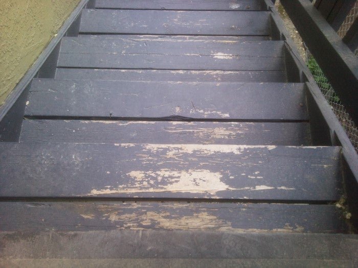A freshly painted charcoal exterior staircase with a durable slip-resistant finish.