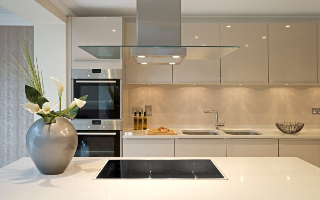 A modern kitchen with a smooth painted backsplash area instead of traditional tiles.