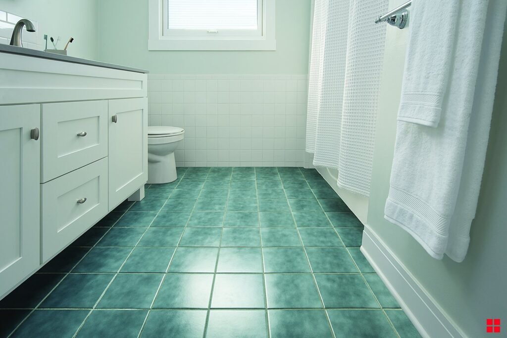 A modern walk-in shower with a freshly painted, slip-resistant floor and neutral tiles.