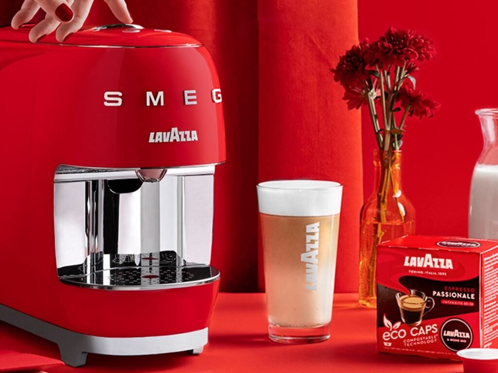 A modern pod coffee maker on a kitchen counter with a fresh cup.