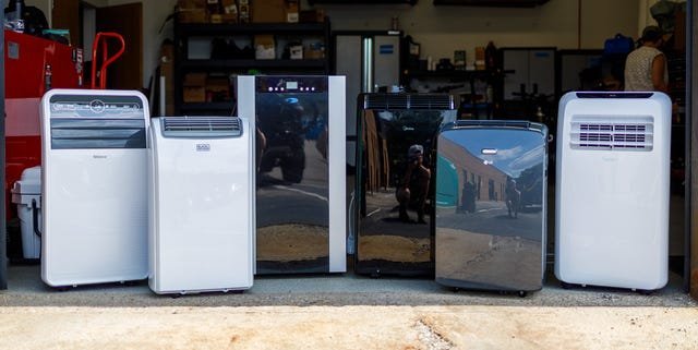 A modern portable air conditioner cooling a well-organized garage workspace efficiently.