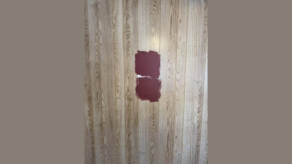 A professional woodworker applying the best primer for veneer in a bright workshop.