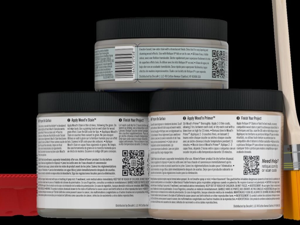 A paint brush and primer can resting on a weathered wood surface outdoors.