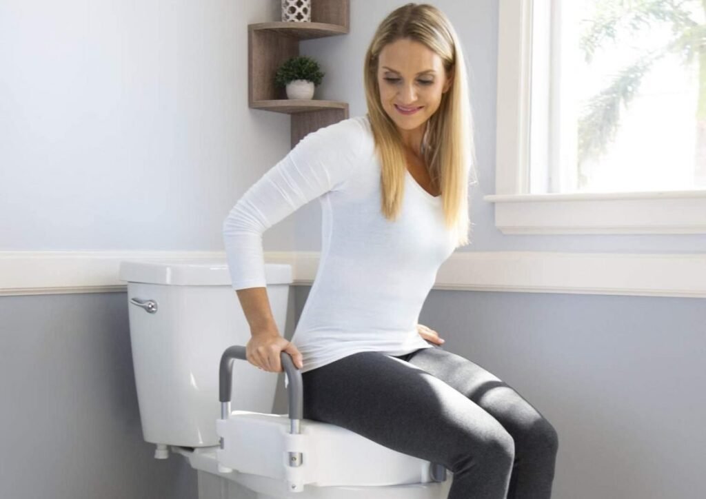A modern raised toilet seat installed in a bright and accessible senior-friendly bathroom.