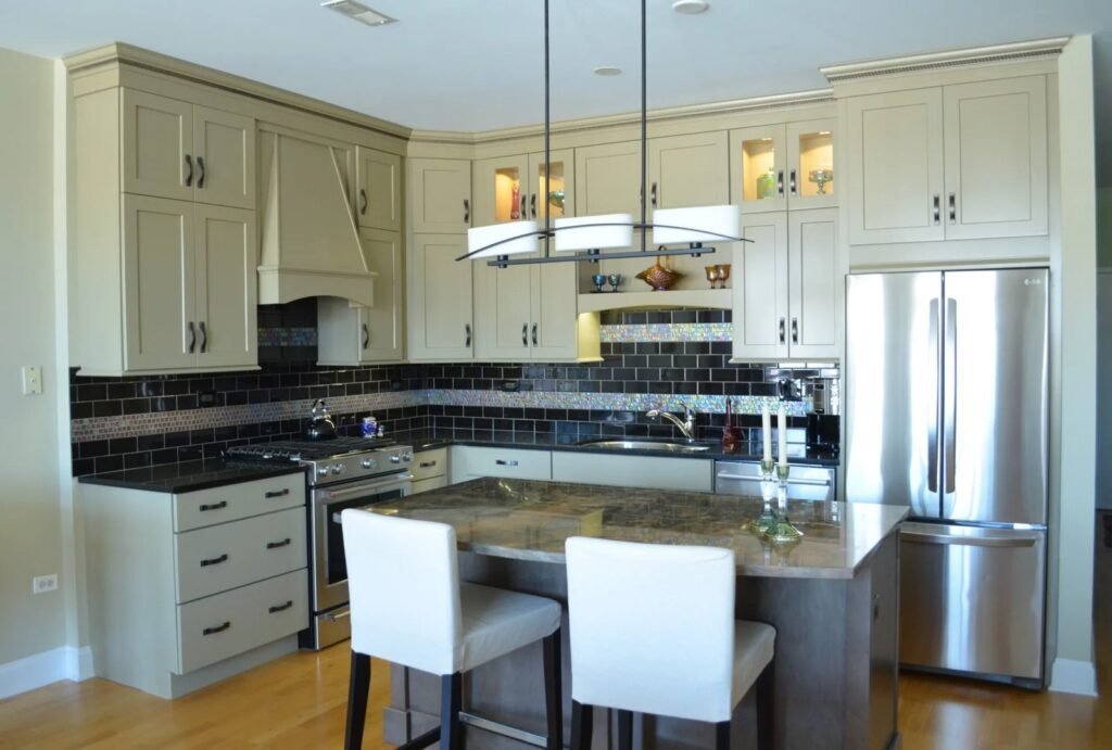 A beautifully designed modern kitchen featuring high quality semi custom cabinets and marble countertops.