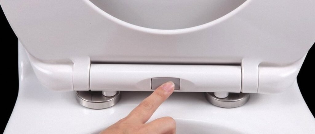 A modern white soft close toilet seat positioned in a bright, contemporary bathroom.