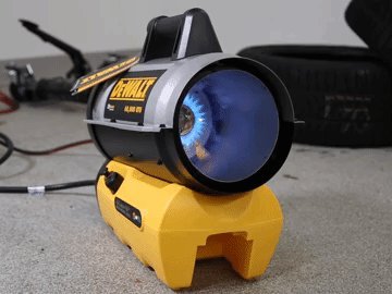 A modern space heater provides warmth inside a tidy, well-organized home garage.