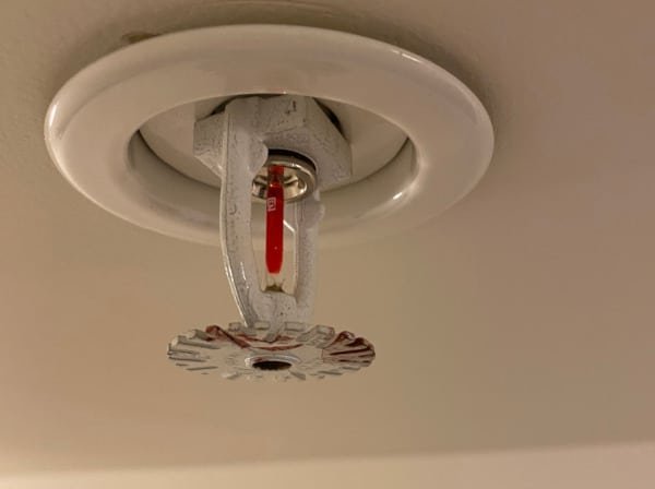 High-quality sprinkler head for dirty water resting on a wooden garden workbench.