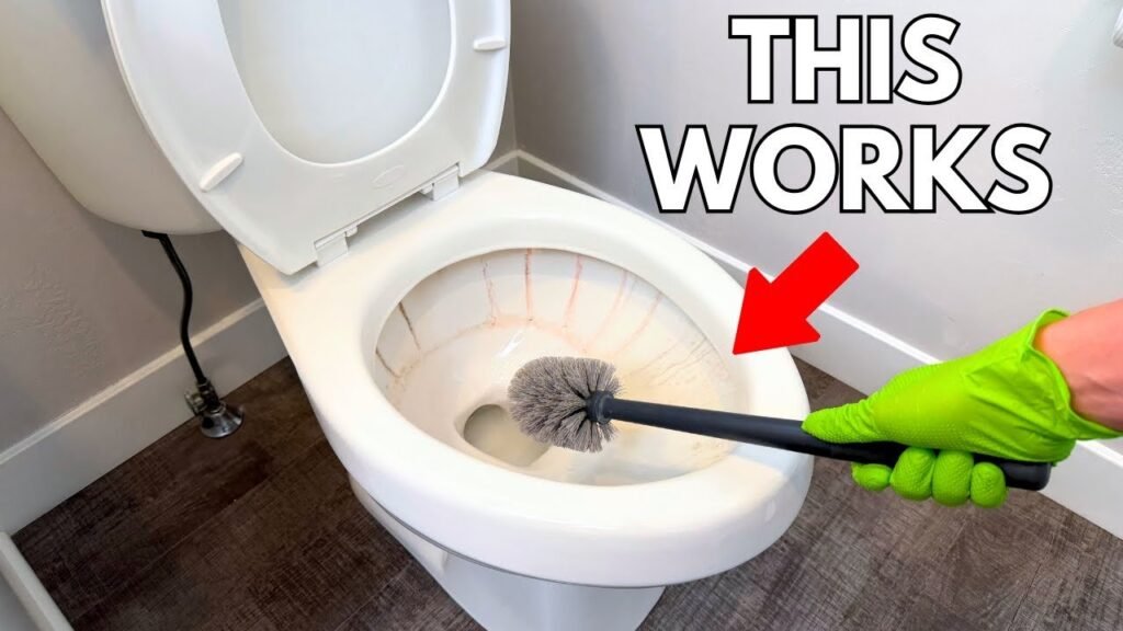 A microfiber cloth and cleaning spray resting on a clean white toilet seat.