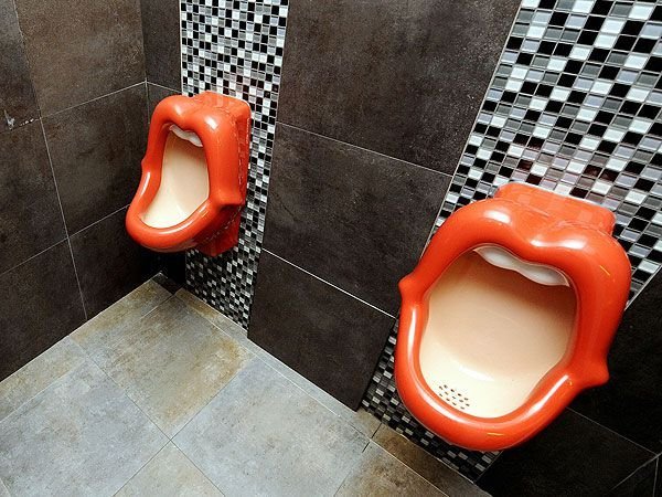 A premium ergonomic toilet seat installed in a bright, modern, minimalist designer bathroom.