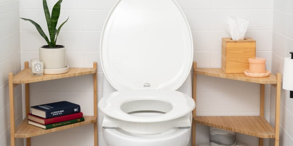 A modern accessible toilet seat designed for comfort in a bright, clean, residential bathroom.