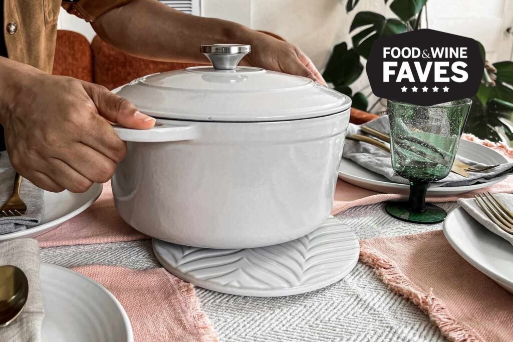 A heat-resistant trivet protects a white quartz countertop from a hot cast iron pot.