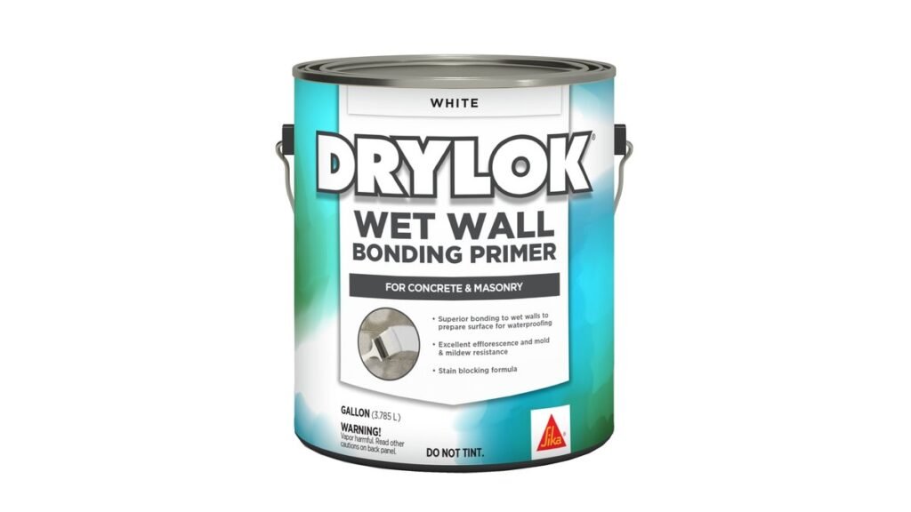 A professional painter applying waterproofing primer to drywall in a bright home renovation.