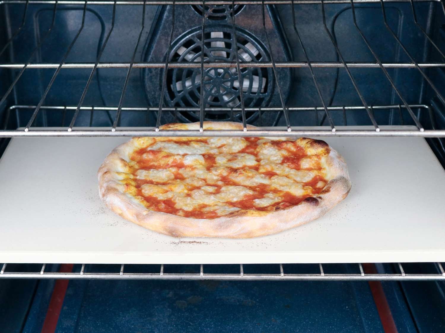 Tools and ingredients arranged on a kitchen counter for troubleshooting pizza baking.