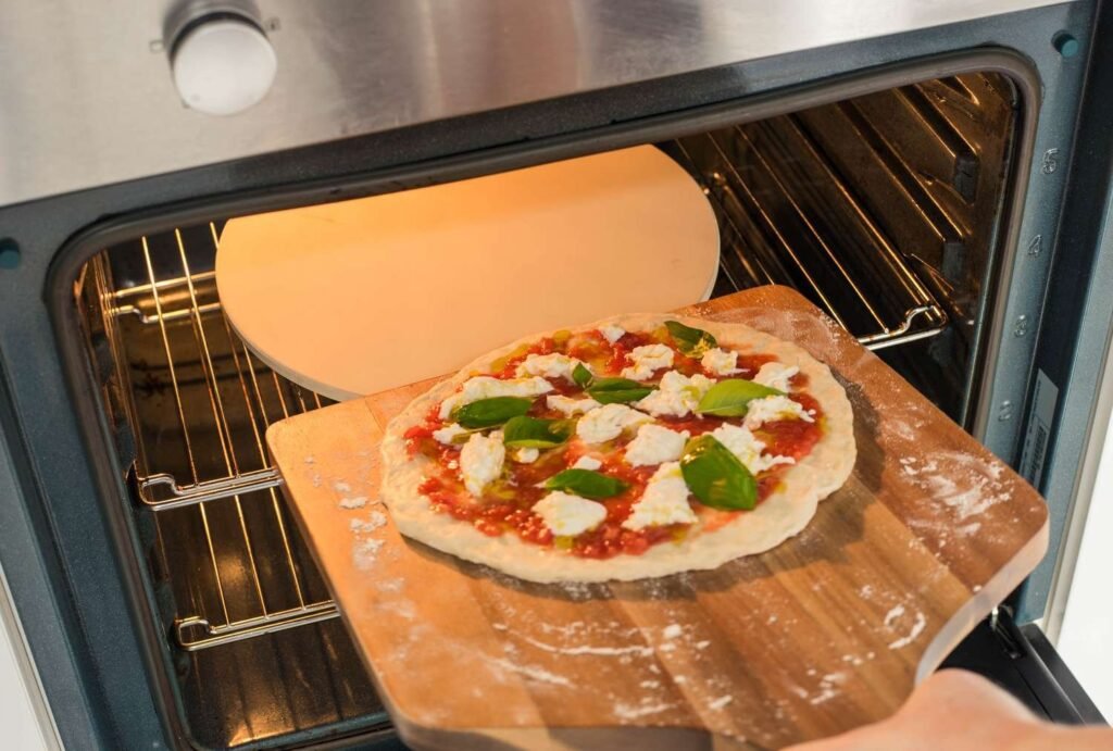 A delicious artisan pizza cooking on a stone inside a home oven.