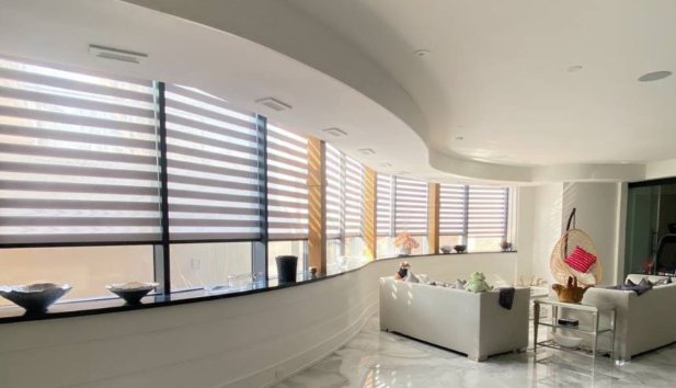 Custom Roman shades on a short wide window in a modern living room.