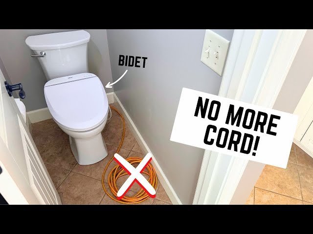 A modern bathroom interior featuring a clean white bidet toilet seat installation.