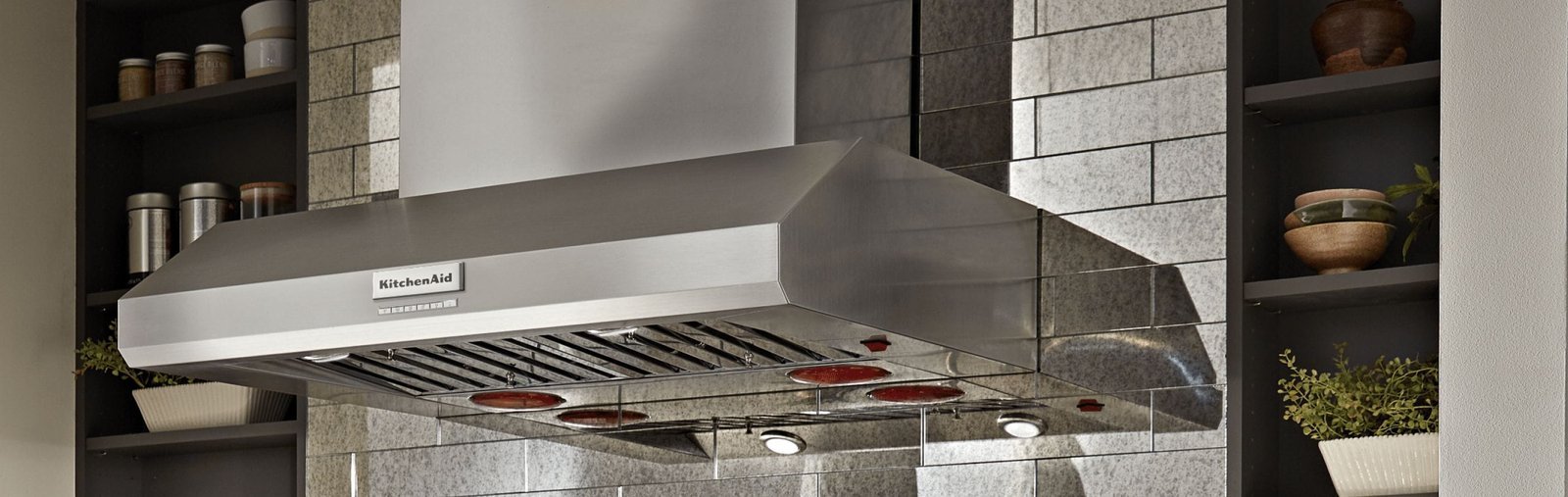 A digital air quality monitor placed in a clean kitchen to maintain air standards.