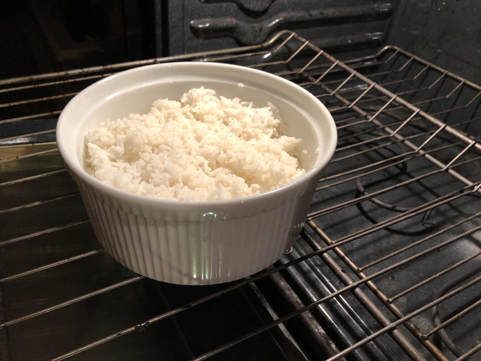 A large dish of rice baking in an oven to save stovetop burner space.