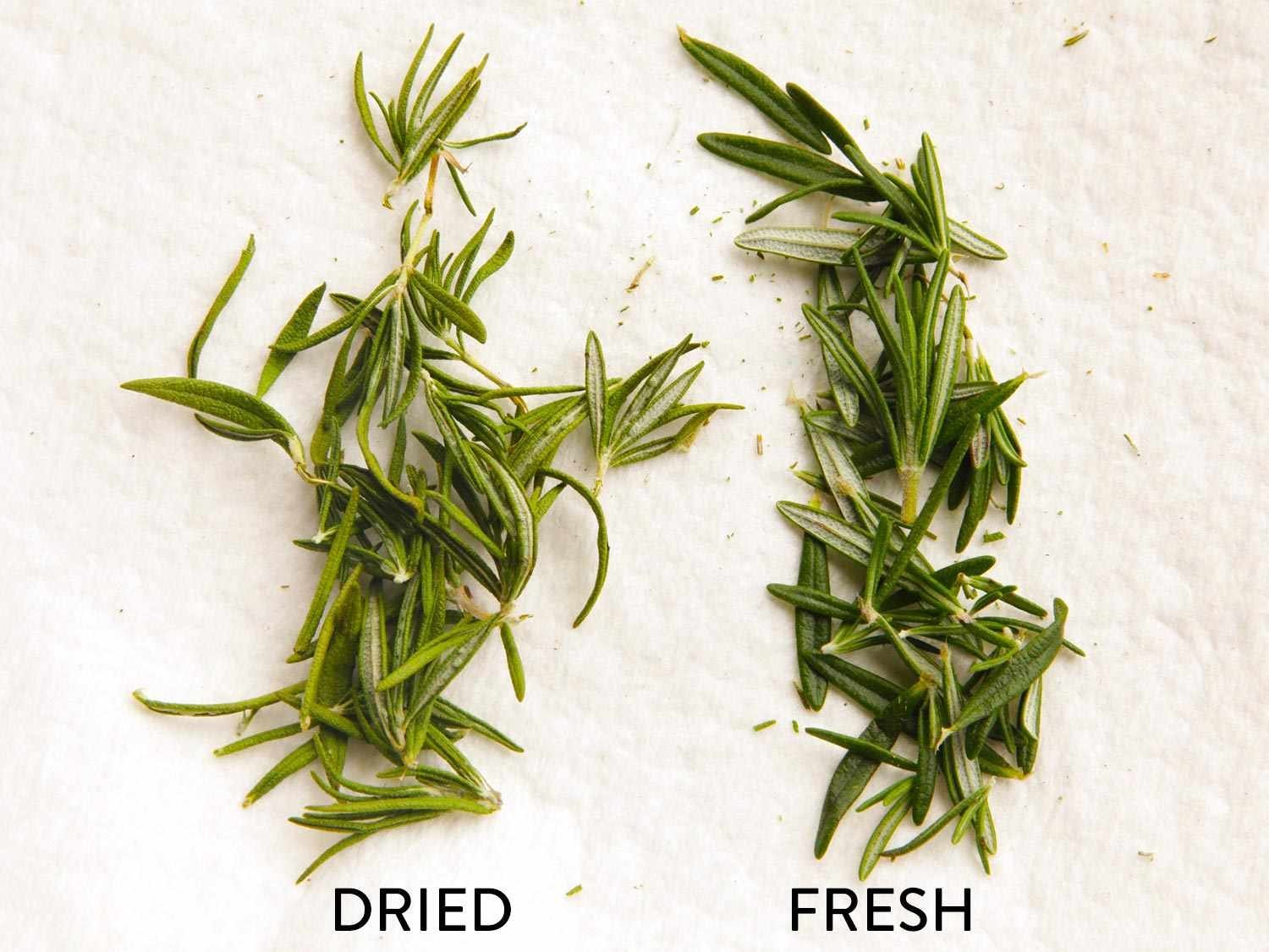 Freshly picked rosemary and thyme sprigs ready for the oven drying process.
