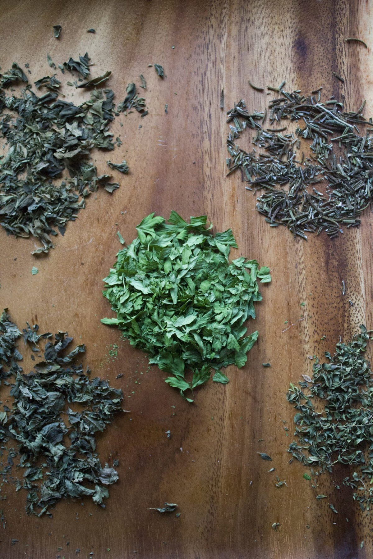 Checking the brittle texture of dried herbs to ensure they are preserved correctly.