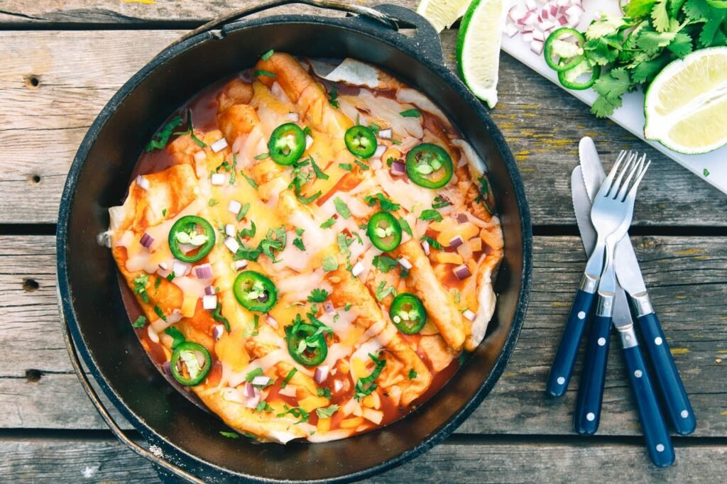 A delicious casserole cooking in a portable camping oven at a scenic campsite.
