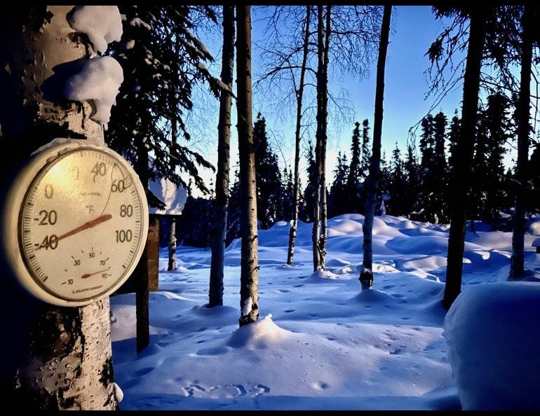 Comparing an accurate outdoor thermometer with a faulty unit showing internal condensation.