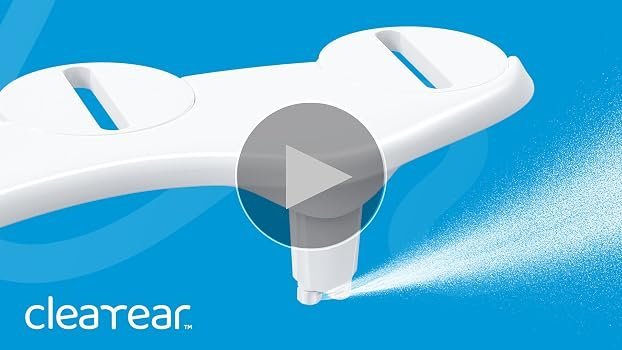 A modern elongated bidet seat installed on a white toilet in a bright bathroom.