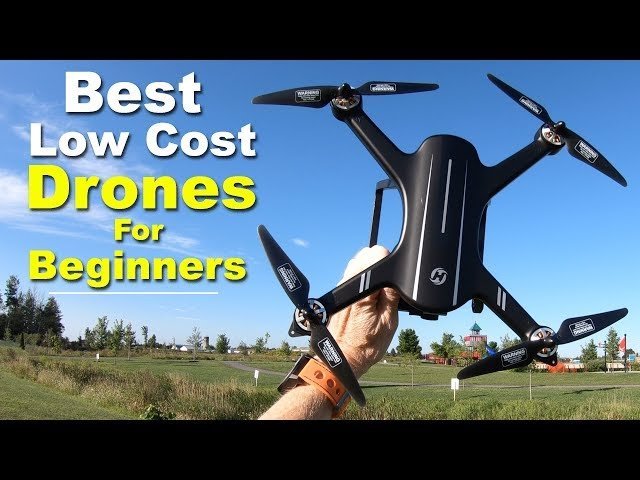 A compact starter drone resting on a wooden table in a sunny park.