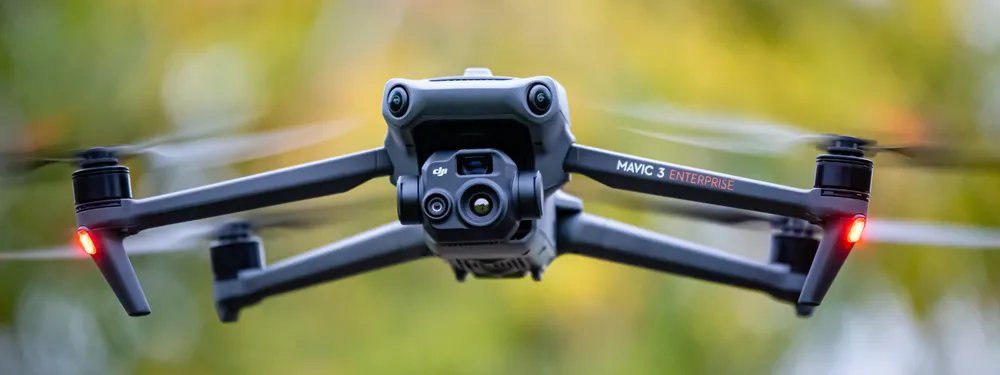 The DJI Mavic 3T thermal drone sits on a rocky cliffside for a review.