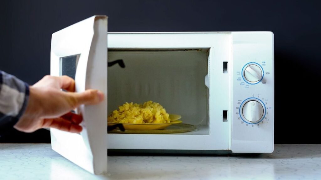 A modern microwave sits on a kitchen counter, illustrating the effects of heating food.