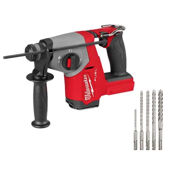 A heavy sledgehammer leaning against concrete next to a small claw hammer.