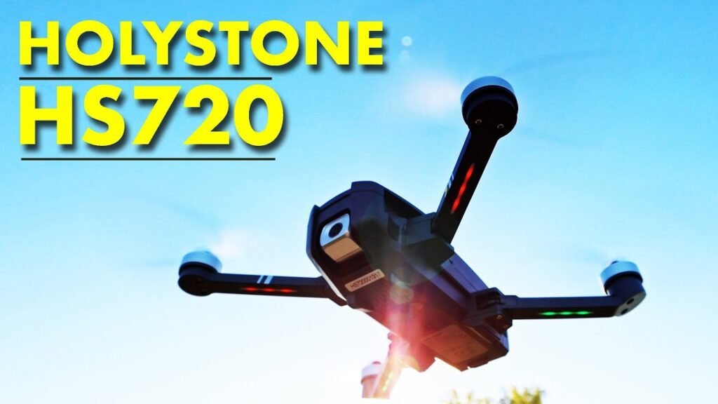 The Holy Stone HS720 drone rests on a wooden table in a park.