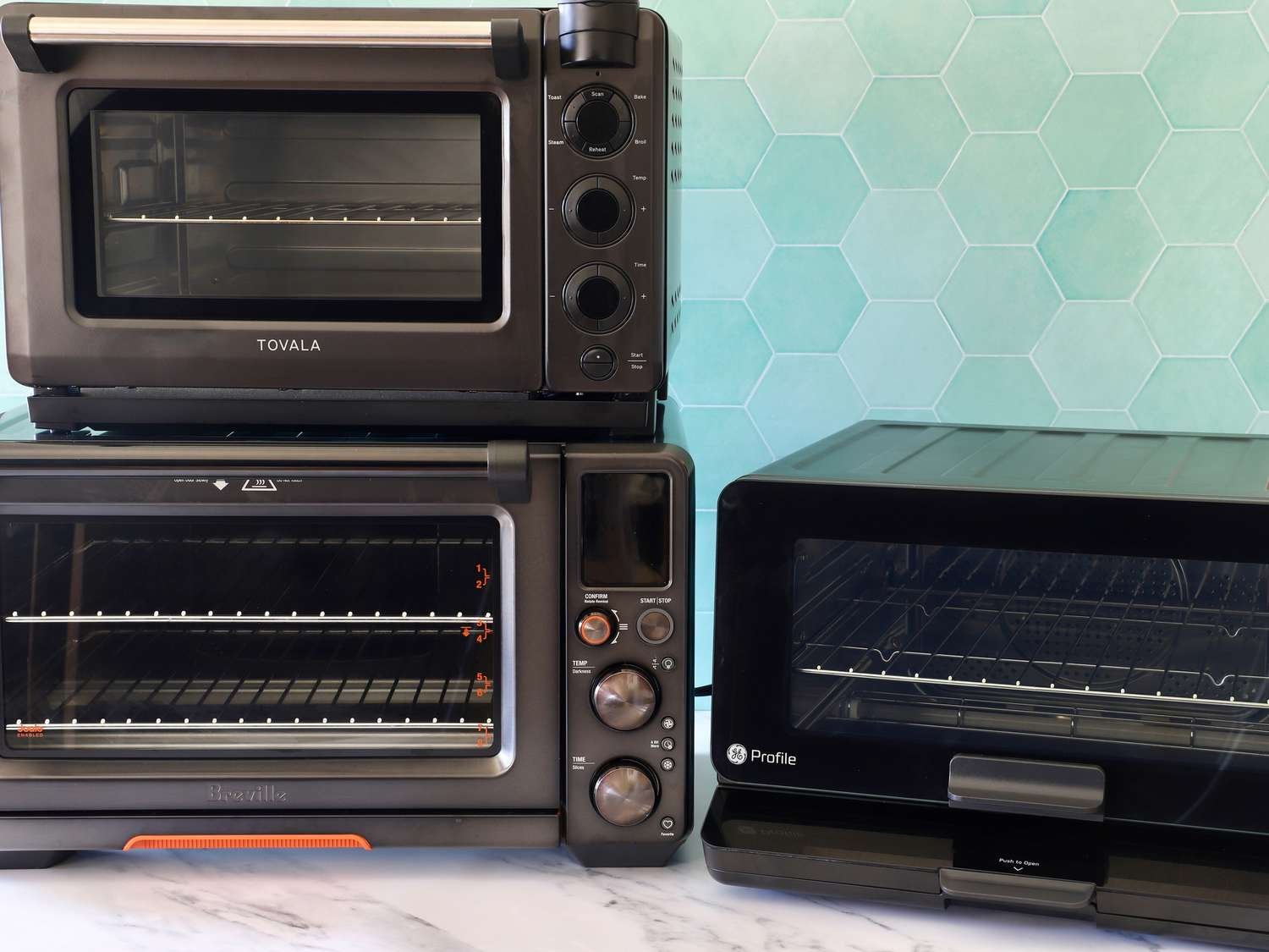 A homeowner using an ergonomic wall oven in a bright, modern kitchen remodel.