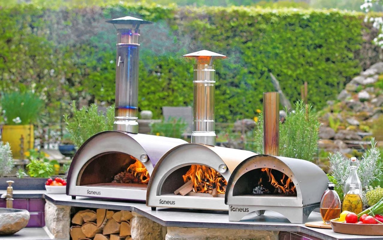 Cleaning the stone base of a pizza oven with a brush.