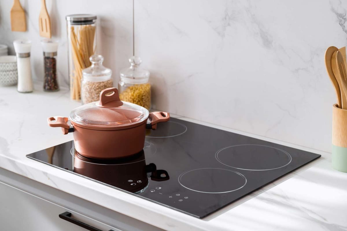 A person researching stove specifications and costs in a bright kitchen.