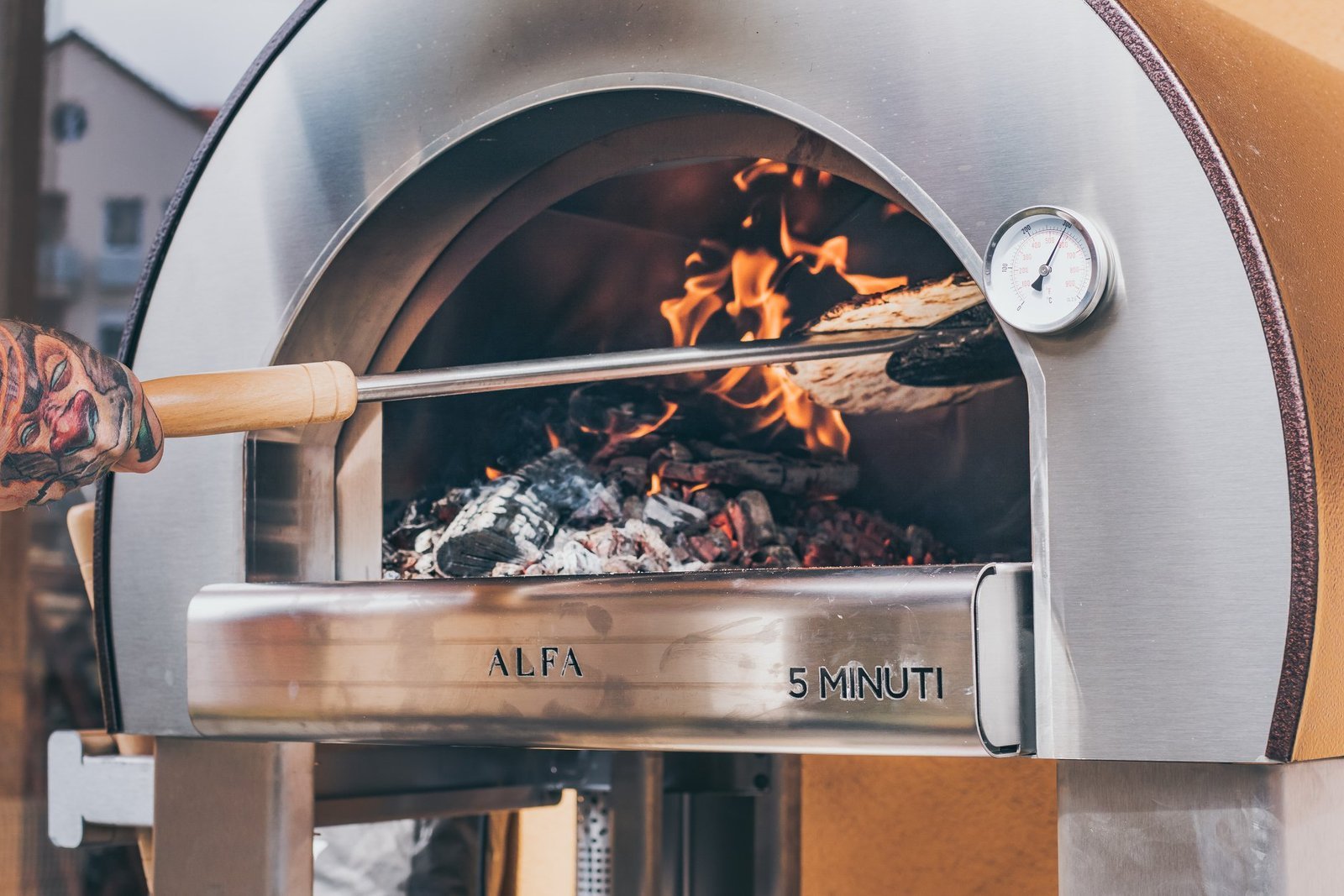 A person cleaning the interior of a modern oven with a cloth.